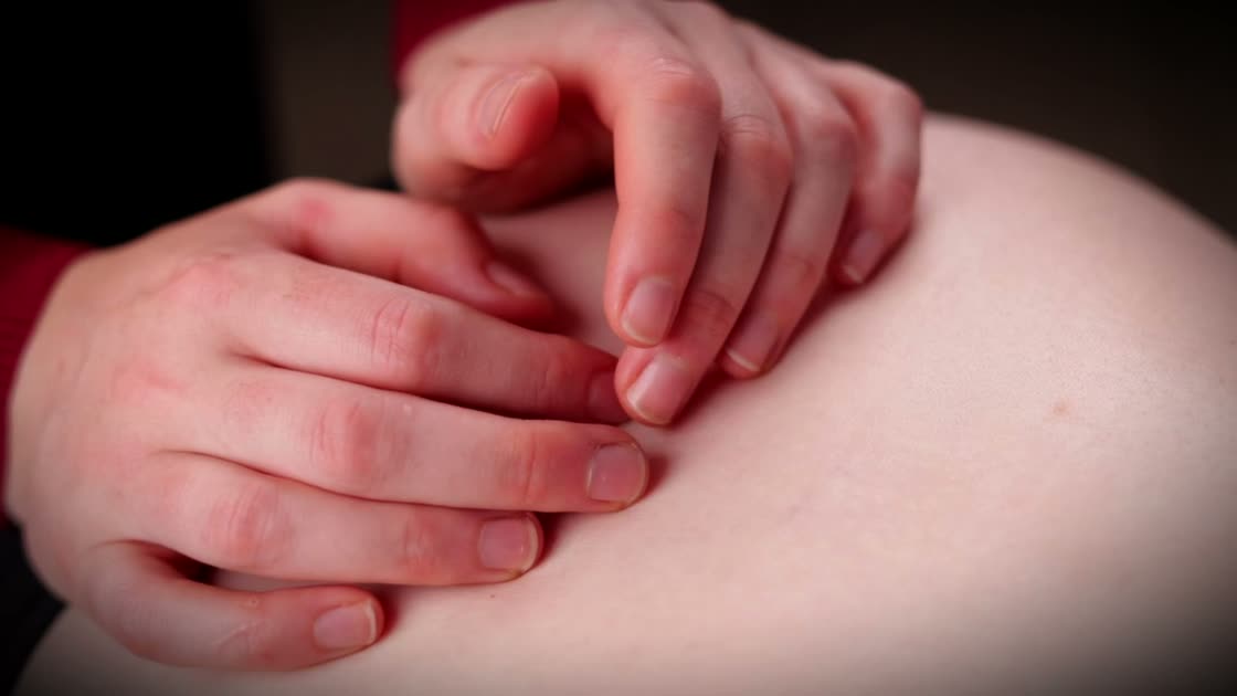 Gabrielle Brennan's hands doing release work on a pregnant client.